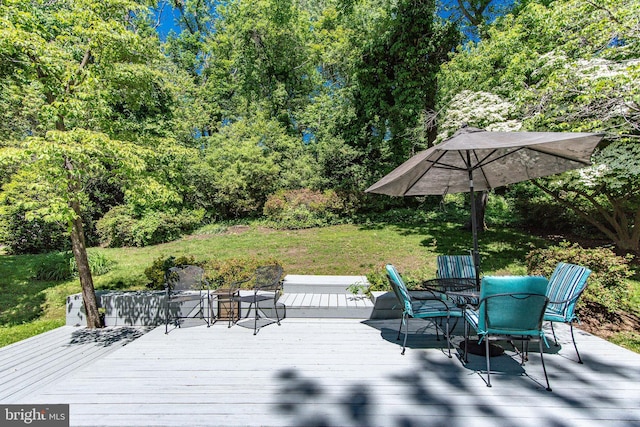 wooden terrace with outdoor dining area