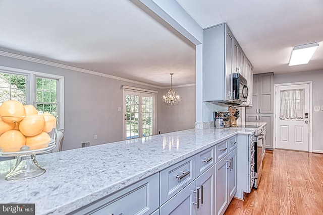 kitchen with black microwave, gray cabinets, stainless steel electric range, light wood-type flooring, and crown molding