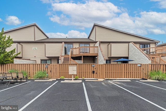 105 120th St Unit 87, Ocean City, MD 21842 - uncovered parking lot with a gate, fence, and stairway