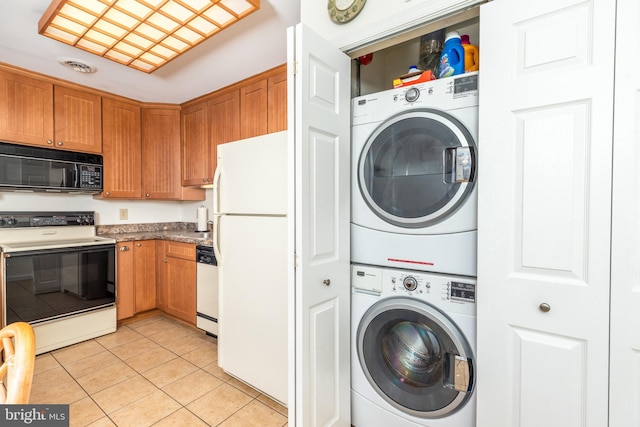 105 120th St Unit 87, Ocean City, MD 21842 - laundry area with stacked washing machine and dryer and light tile patterned flooring