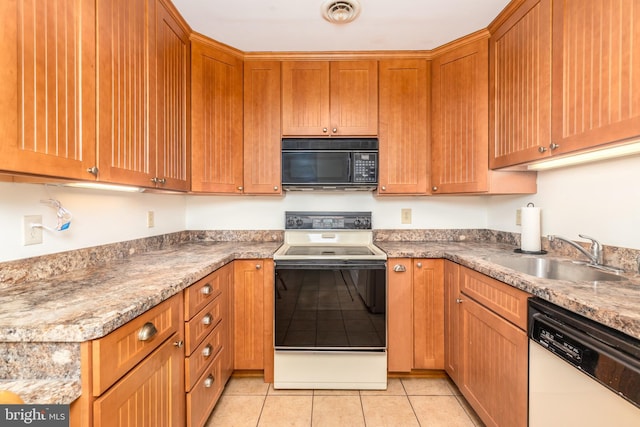 105 120th St Unit 87, Ocean City, MD 21842 - kitchen featuring white appliances, a sink, light tile patterned floors, and brown cabinetry