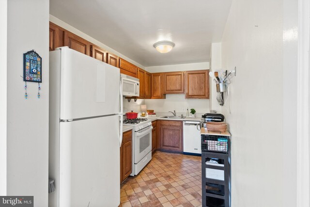 3000 Spout Run Pkwy Unit B606, Arlington, VA 22201 - kitchen with white appliances, light countertops, brown cabinetry, and a sink