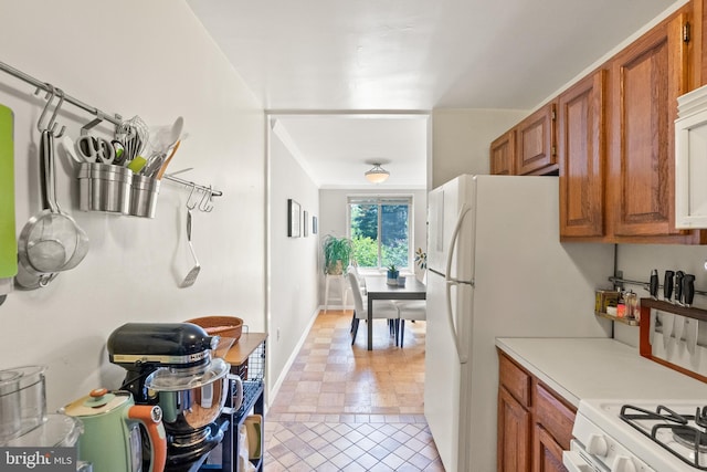 3000 Spout Run Pkwy Unit B606, Arlington, VA 22201 - kitchen featuring light countertops, brown cabinetry, light tile patterned flooring, and baseboards
