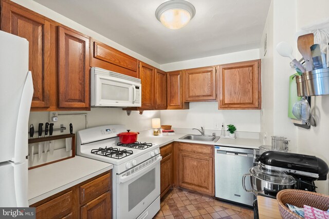 3000 Spout Run Pkwy Unit B606, Arlington, VA 22201 - kitchen featuring white appliances, a sink, light countertops, brown cabinets, and light tile patterned flooring