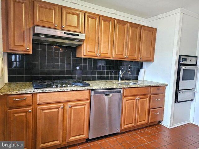1506 N 13th St, Philadelphia, PA 19122 - kitchen featuring stainless steel appliances, under cabinet range hood, a sink, a warming drawer, and dark tile patterned floors
