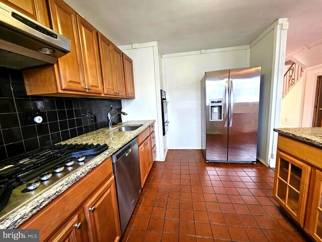 1506 N 13th St, Philadelphia, PA 19122 - kitchen featuring appliances with stainless steel finishes, a sink, range hood, decorative backsplash, and brown cabinetry
