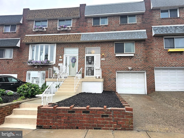 1506 N 13th St, Philadelphia, PA 19122 - multi unit property with a garage, brick siding, and roof with shingles