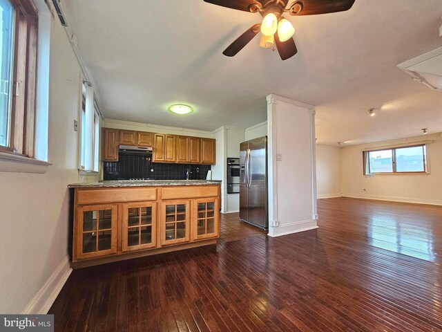 1506 N 13th St, Philadelphia, PA 19122 - kitchen with stainless steel fridge, brown cabinetry, dark wood-style floors, open floor plan, and baseboards