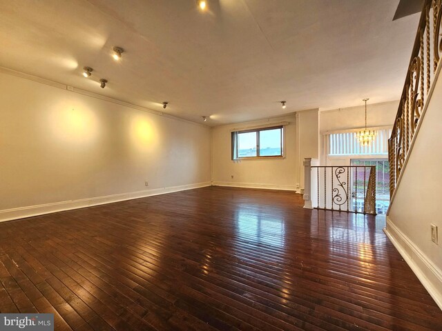 1506 N 13th St, Philadelphia, PA 19122 - spare room with dark wood-type flooring, a chandelier, baseboards, and crown molding