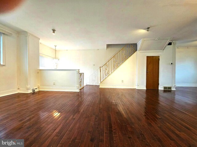 1506 N 13th St, Philadelphia, PA 19122 - unfurnished living room featuring hardwood / wood-style flooring, stairs, baseboards, and a chandelier