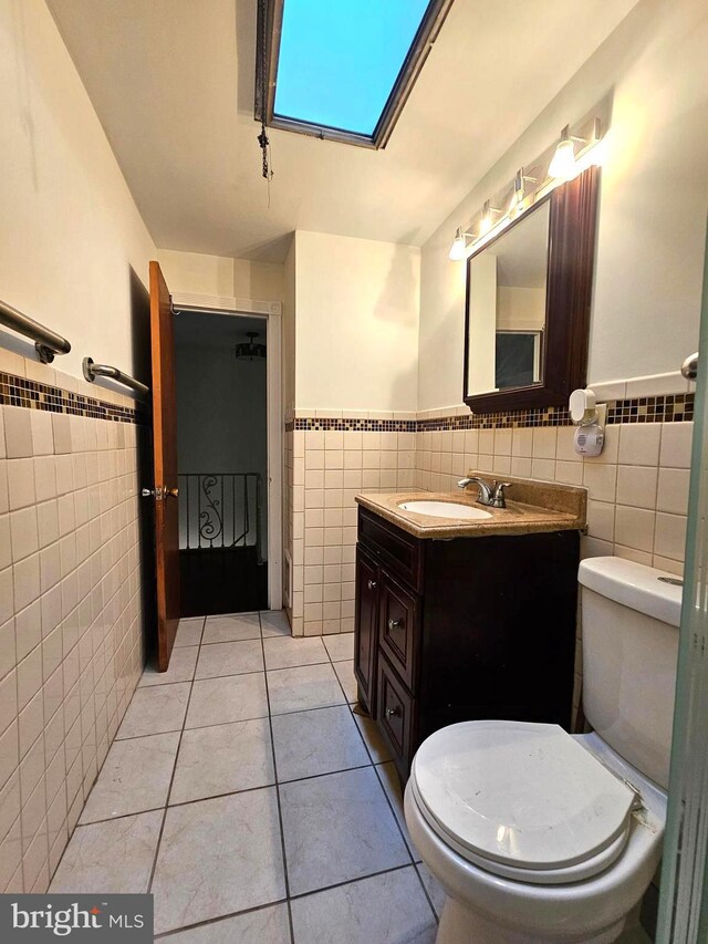 1506 N 13th St, Philadelphia, PA 19122 - bathroom featuring tile walls, a wainscoted wall, tile patterned flooring, toilet, and vanity