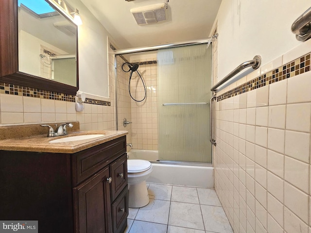 1506 N 13th St, Philadelphia, PA 19122 - full bath with tile walls, shower / bath combination with glass door, vanity, toilet, and tile patterned floors