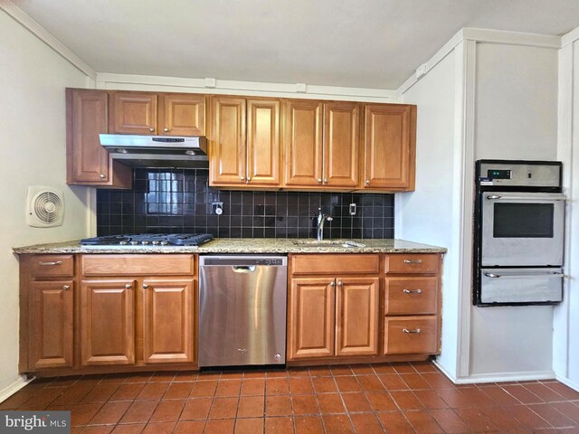 1506 N 13th St, Philadelphia, PA 19122 - kitchen featuring stainless steel appliances, a warming drawer, under cabinet range hood, a sink, and decorative backsplash