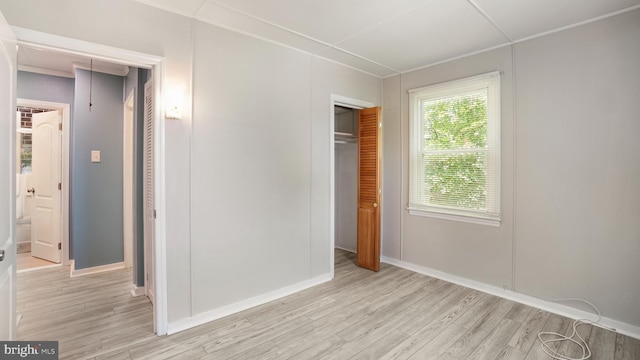 1802 Kittyhawk Rd, Baltimore, MD 21221 - unfurnished bedroom featuring light wood finished floors, a closet, and baseboards