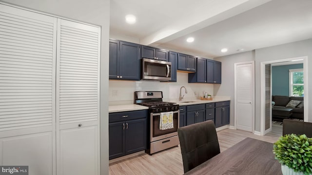 1802 Kittyhawk Rd, Baltimore, MD 21221 - kitchen featuring appliances with stainless steel finishes, a sink, light wood-style flooring, light countertops, and recessed lighting