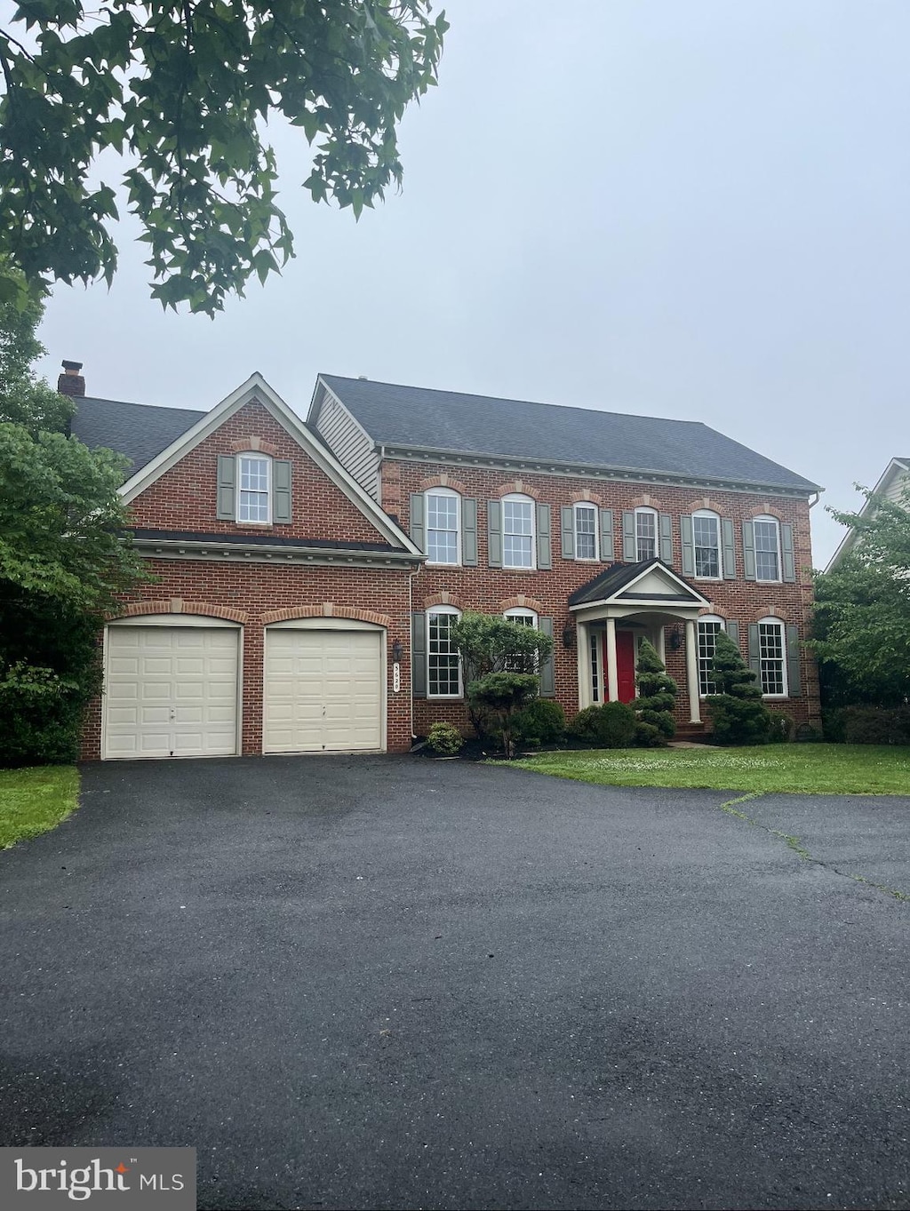 3620 Denison St, Frederick, MD 21704 - colonial home featuring asphalt driveway, brick siding, and a garage