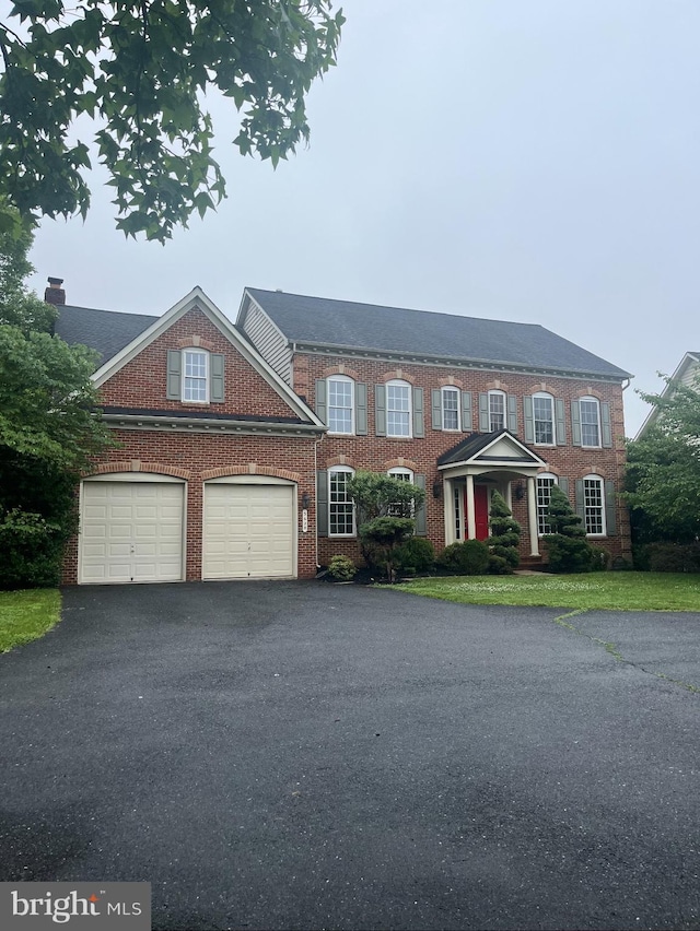 3620 Denison St, Frederick, MD 21704 - colonial home featuring asphalt driveway, brick siding, and a garage