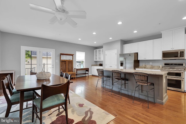 dining area featuring healthy amount of natural light, light wood-style floors, recessed lighting, and ceiling fan