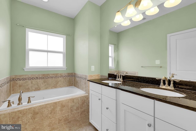bathroom featuring a bath, double vanity, and a chandelier