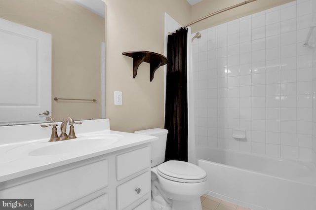 bathroom featuring vanity, toilet, tile patterned flooring, and shower / tub combo