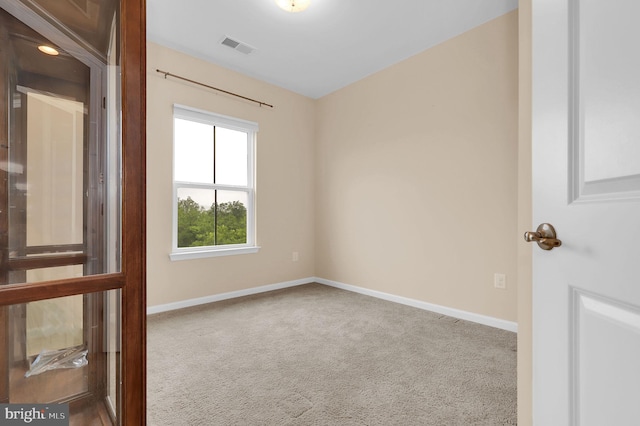 carpeted spare room with baseboards