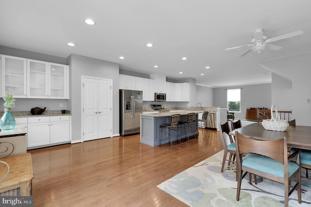 dining room featuring recessed lighting, light wood-style flooring, a ceiling fan, and ornamental molding