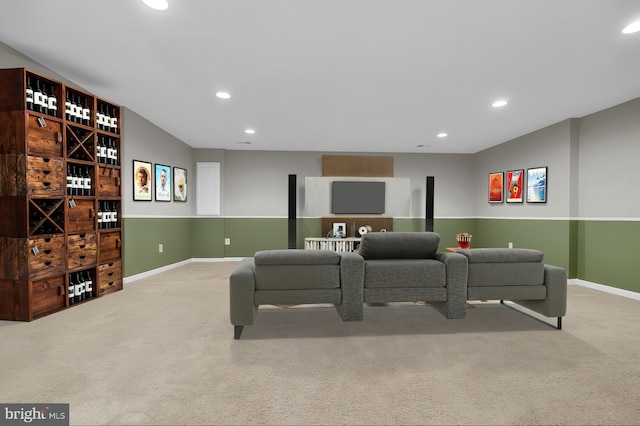 carpeted living area with recessed lighting and baseboards