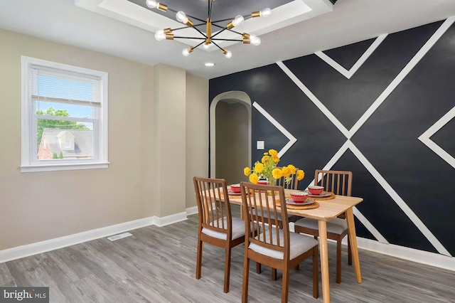 1208 Krueger Ave, Rosedale, MD 21237 - dining area with arched walkways, wood finished floors, baseboards, and a chandelier