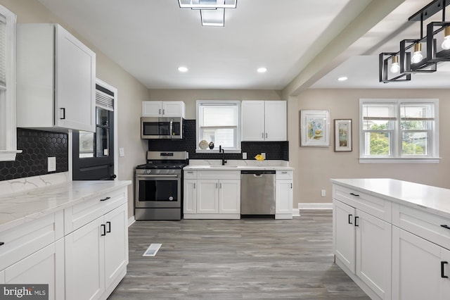 1208 Krueger Ave, Rosedale, MD 21237 - kitchen with stainless steel appliances, a sink, decorative backsplash, recessed lighting, and healthy amount of natural light