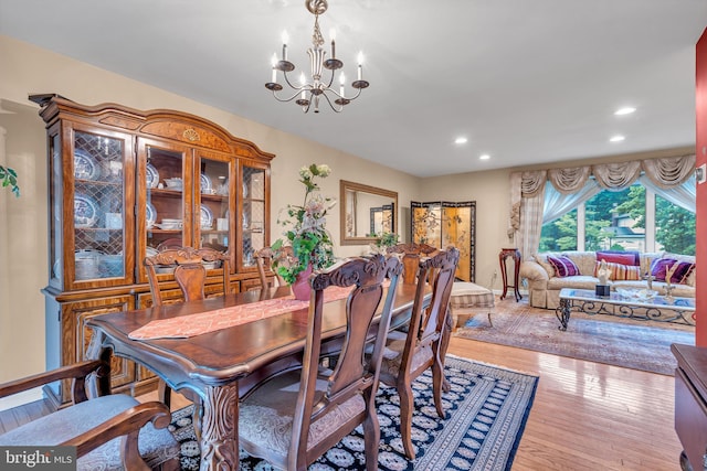 dining room with a chandelier, recessed lighting, and wood finished floors