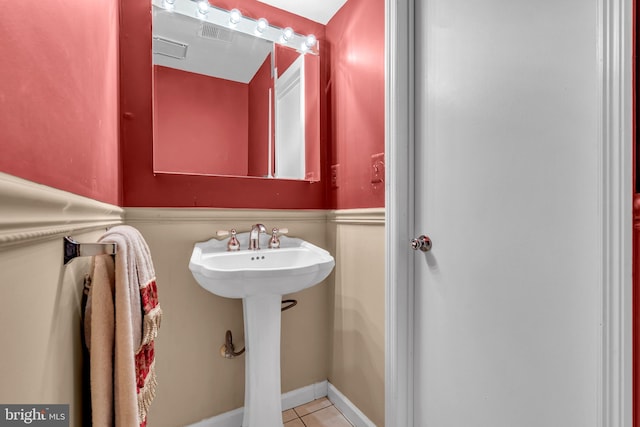 bathroom featuring tile patterned flooring and a sink