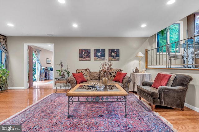living area featuring wood finished floors, recessed lighting, and baseboards