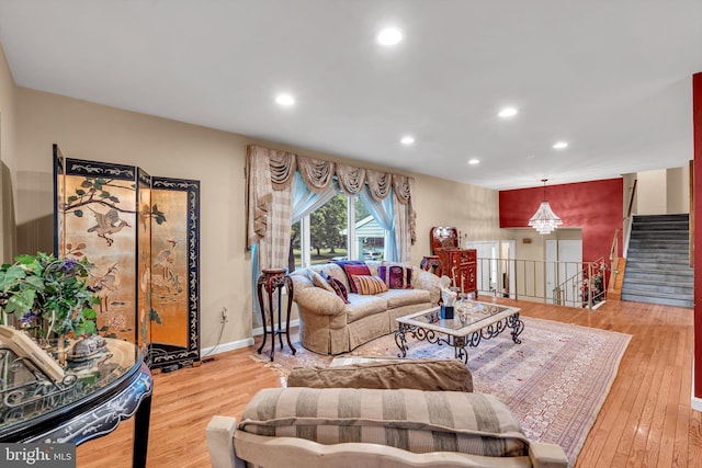 living area featuring recessed lighting, wood finished floors, stairway, and baseboards
