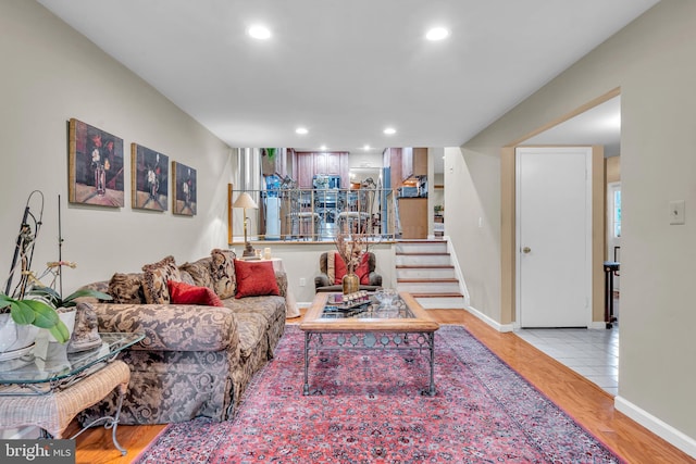 living room with stairway, wood finished floors, recessed lighting, and baseboards