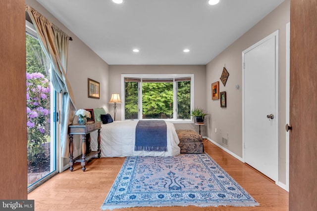 bedroom with recessed lighting, light wood-style floors, and baseboards