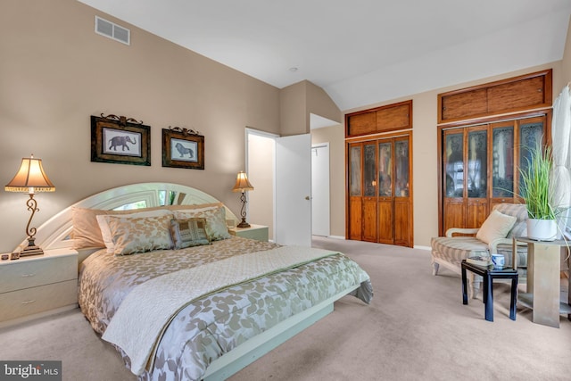 carpeted bedroom with vaulted ceiling