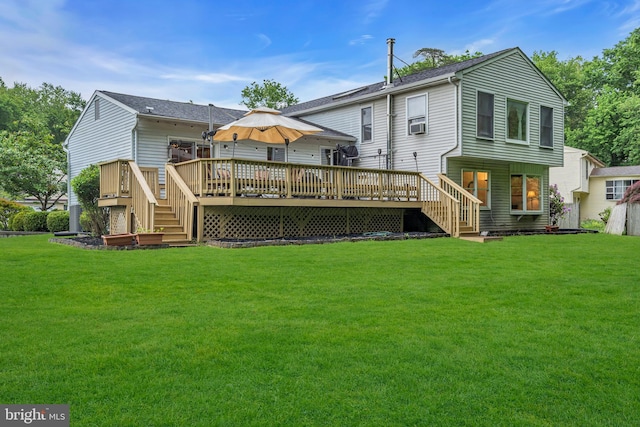 rear view of property featuring stairway, a yard, and a wooden deck