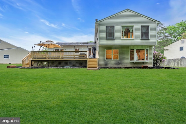 rear view of property featuring a wooden deck and stairway