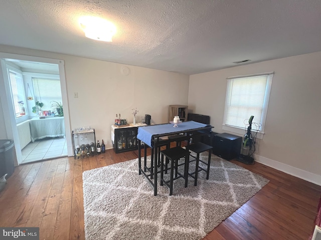 619 S Cameron St, Winchester, VA 22601 - dining space featuring hardwood / wood-style floors, a textured ceiling, and baseboards