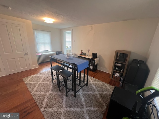 619 S Cameron St, Winchester, VA 22601 - dining area featuring radiator heating unit, wood finished floors, baseboards, and a textured ceiling