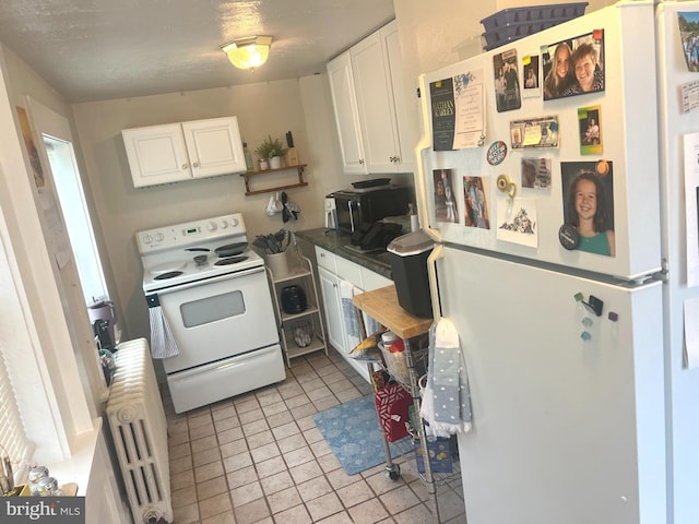 619 S Cameron St, Winchester, VA 22601 - kitchen featuring white appliances, radiator heating unit, white cabinets, dark countertops, and open shelves