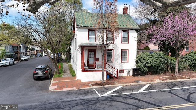 619 S Cameron St, Winchester, VA 22601 - view of property featuring stucco siding, metal roof, and a chimney