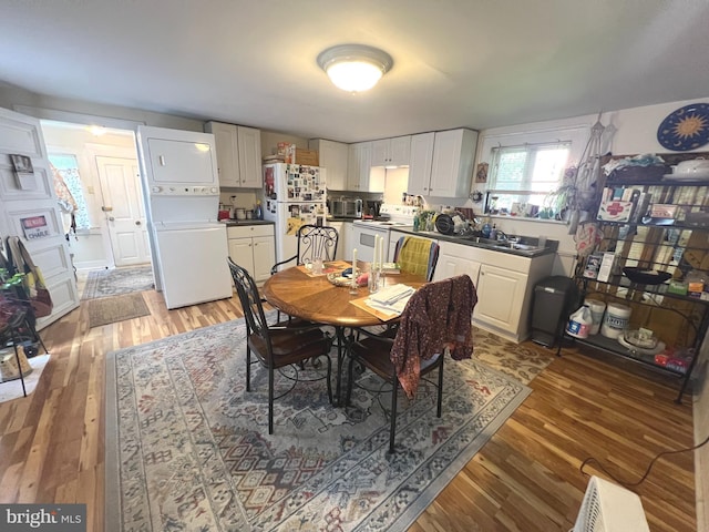 619 S Cameron St, Winchester, VA 22601 - dining area featuring stacked washing machine and dryer and light wood-type flooring