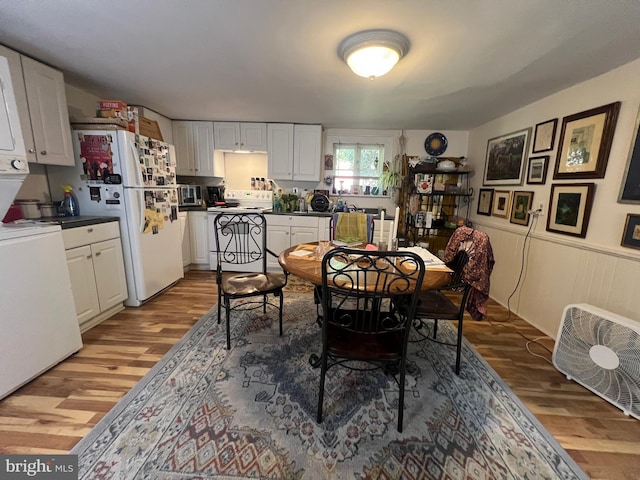 619 S Cameron St, Winchester, VA 22601 - dining room featuring light wood finished floors, stacked washing machine and dryer, and wainscoting