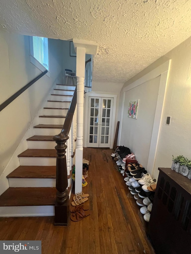 619 S Cameron St, Winchester, VA 22601 - staircase with a textured ceiling and hardwood / wood-style flooring
