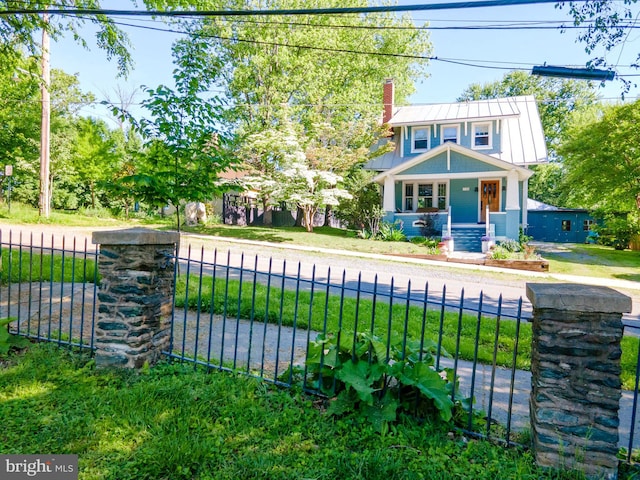 730 Fillmore St, Harpers Ferry, WV 25425 - view of front facade featuring a fenced front yard, metal roof, a chimney, a standing seam roof, and covered porch