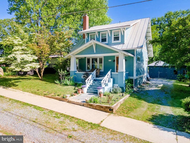 730 Fillmore St, Harpers Ferry, WV 25425 - view of front facade featuring a chimney, a standing seam roof, a porch, a front lawn, and metal roof