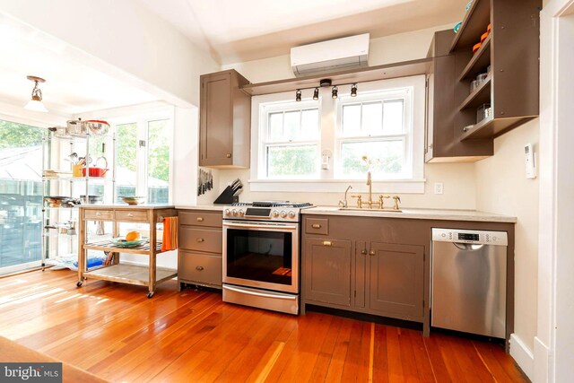 730 Fillmore St, Harpers Ferry, WV 25425 - kitchen featuring appliances with stainless steel finishes, a sink, a wall unit AC, gray cabinets, and open shelves