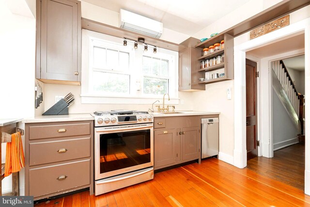 730 Fillmore St, Harpers Ferry, WV 25425 - kitchen featuring stainless steel appliances, a sink, a wall mounted air conditioner, light wood-style floors, and light countertops