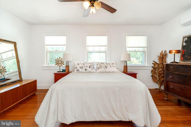 730 Fillmore St, Harpers Ferry, WV 25425 - bedroom featuring wood finished floors, a wall mounted air conditioner, a ceiling fan, and baseboards